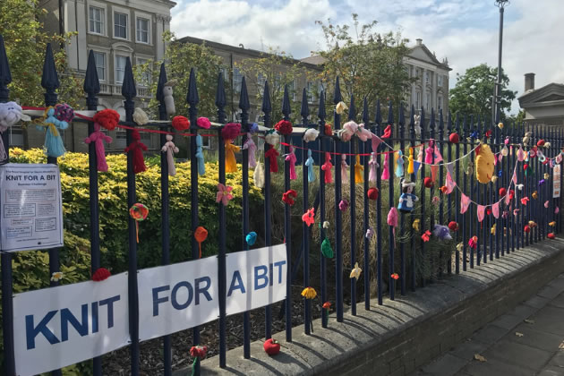Yarn bombs on the gates outside the hospital 