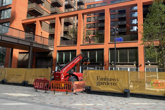 A Digger Parked Next To Posh Flats In Nine Elms