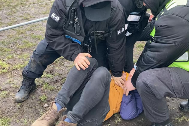 Dimitri being restrained by security guards. Picture: Extinction Rebellion Wandsworth 